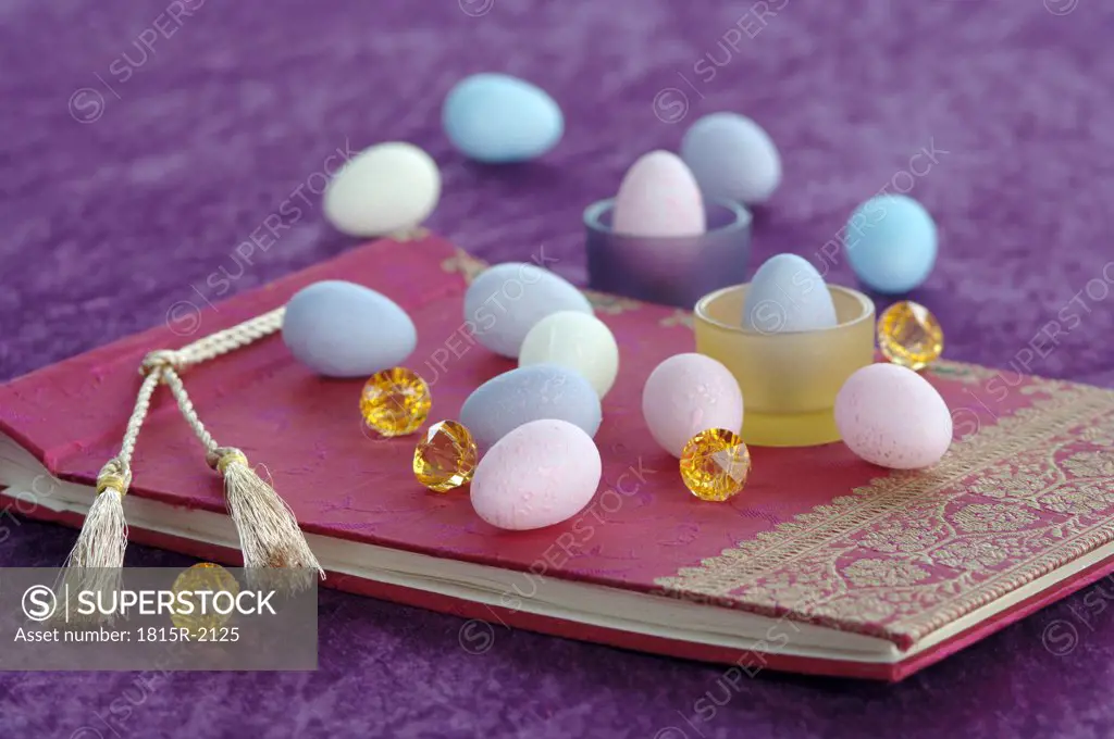 Coloured Easter eggs on book, close-up