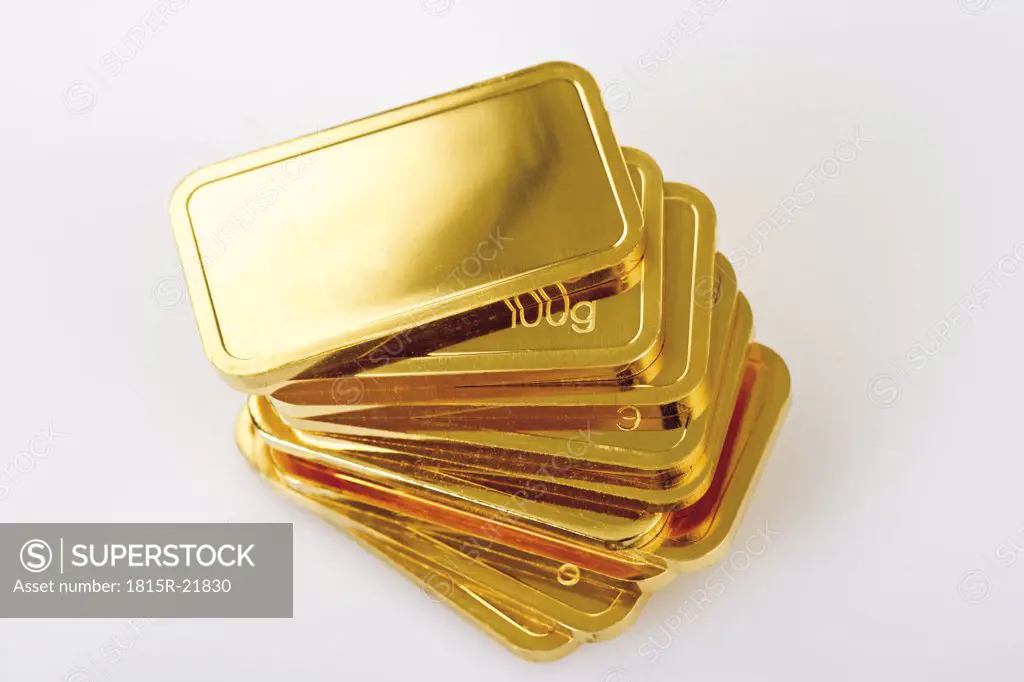 Gold bars on white background, elevated view