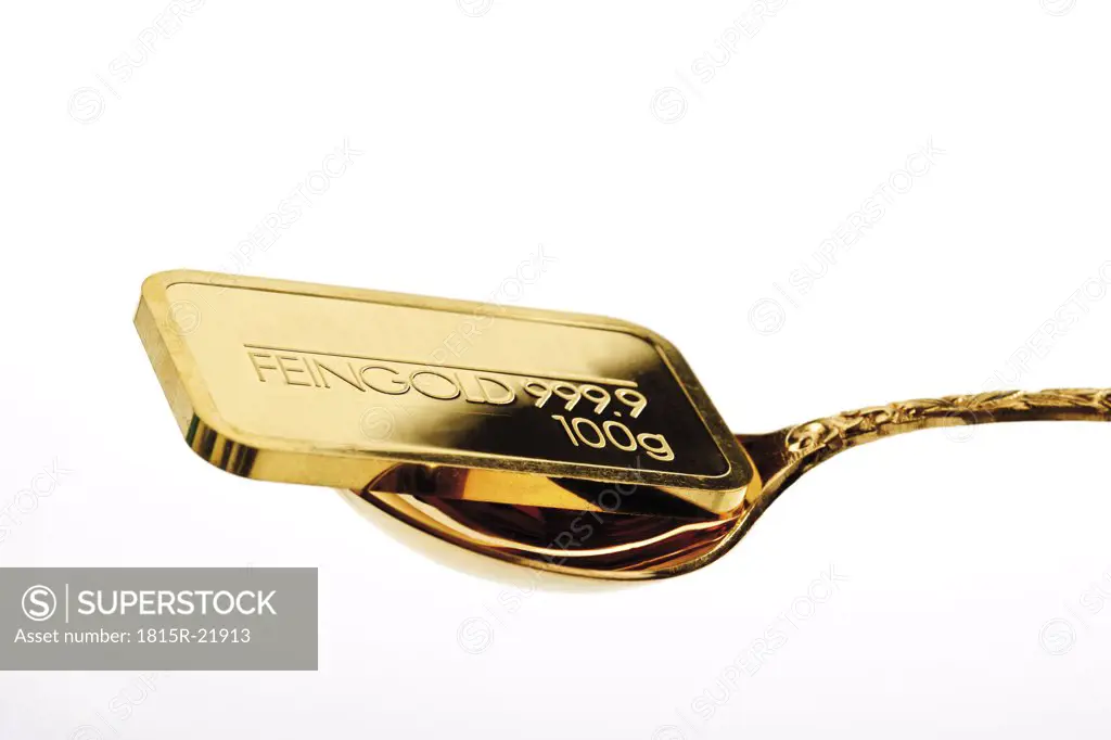 Gold bar on golden spoon