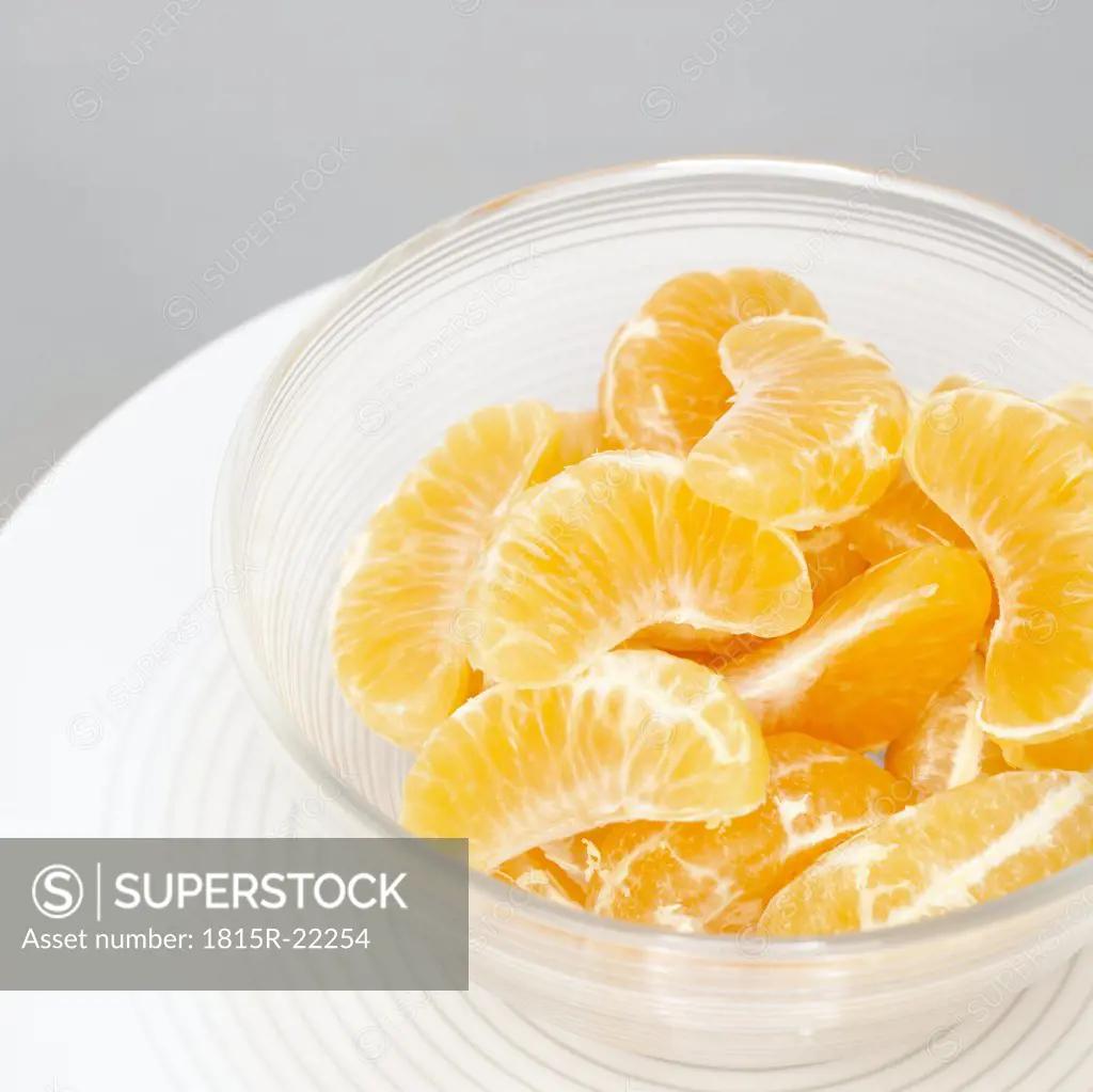 Slices of tangerines in glass bowl, close-up
