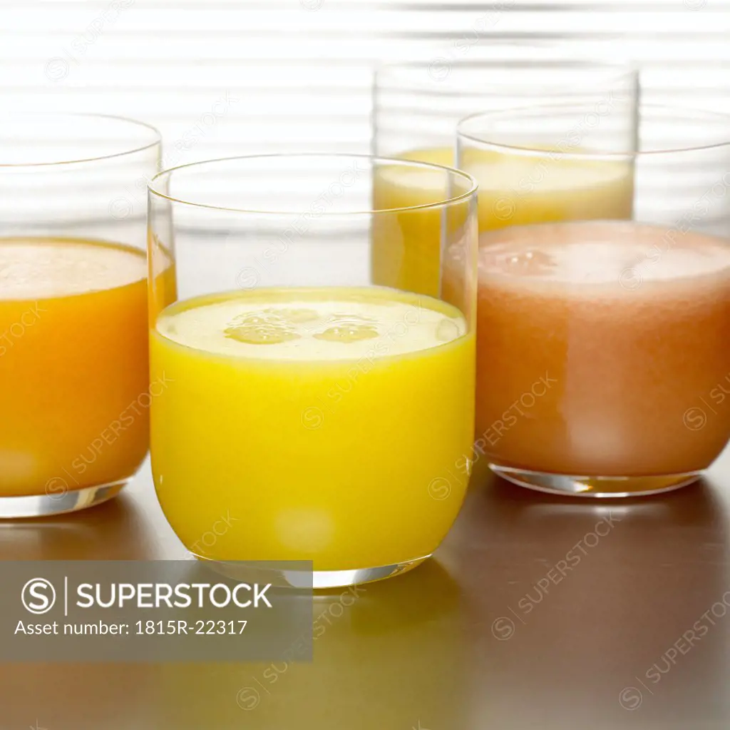 Pineapple juice, orange juice and grapefruit juice in glasses, close-up