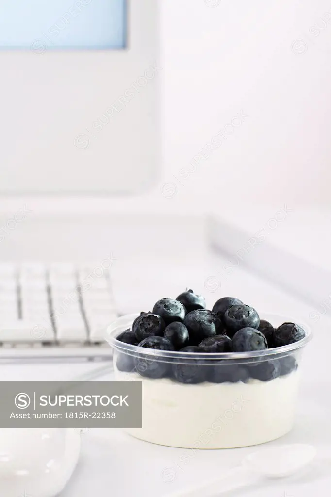 Bowl of blueberry curd on office desk