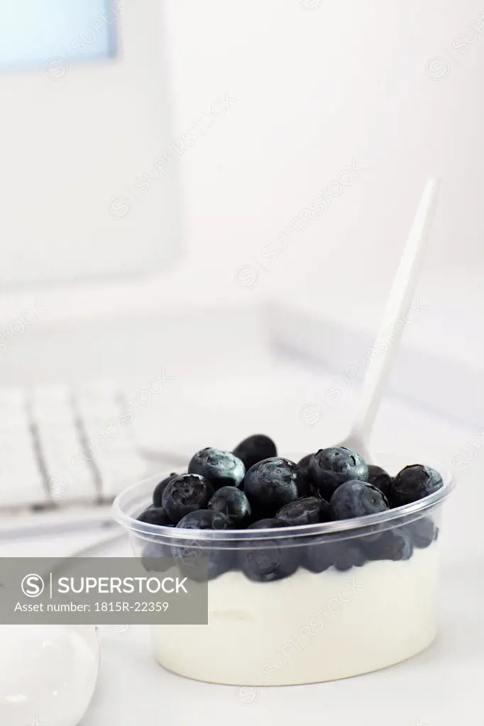 Bowl of blueberry curd on office desk