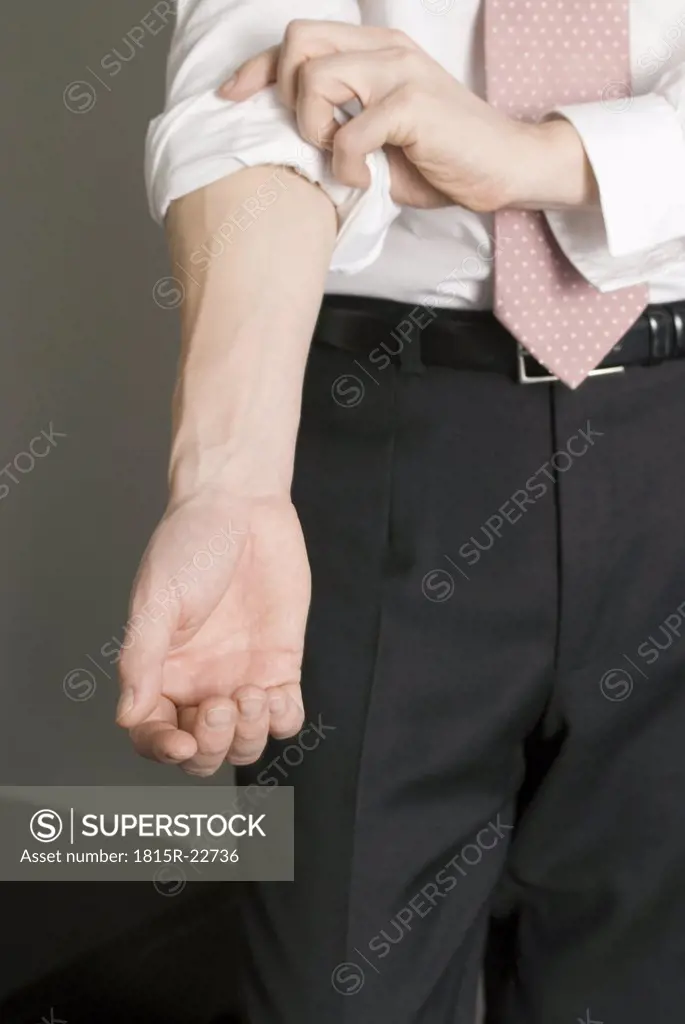 Man rolling up his sleeves