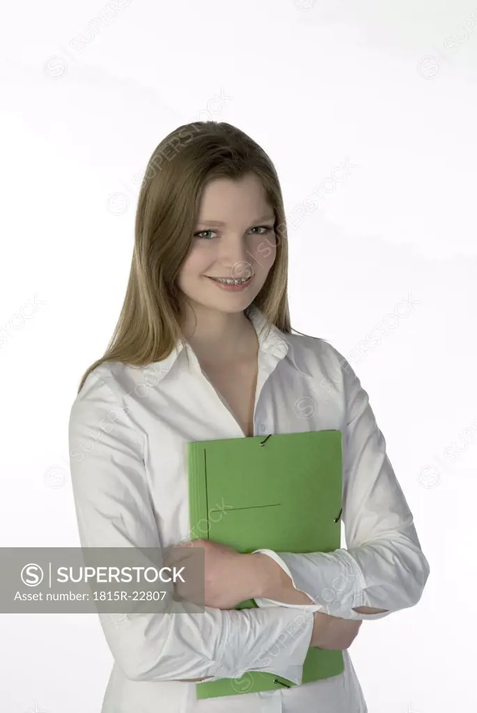 Blonde girl (13-14) with folder, portrait