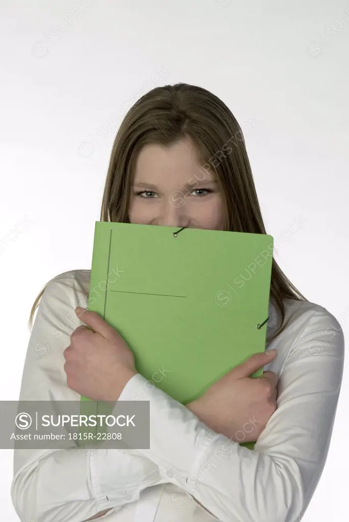 Blonde girl (13-14) with folder, portrait