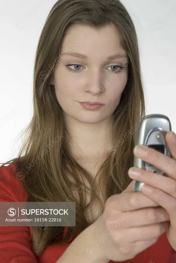 Girl (13-14) using mobile phone, portrait