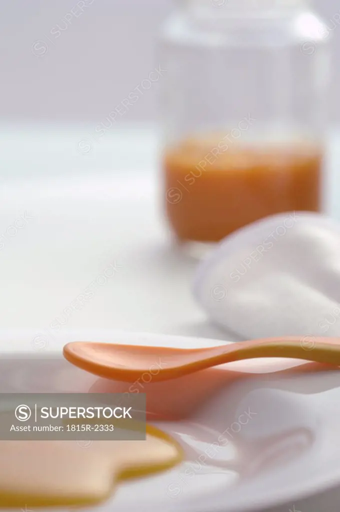 Baby food in plate with spoon, close-up