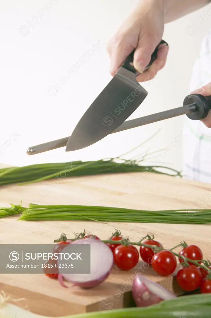 Man sharpening knife, close-up