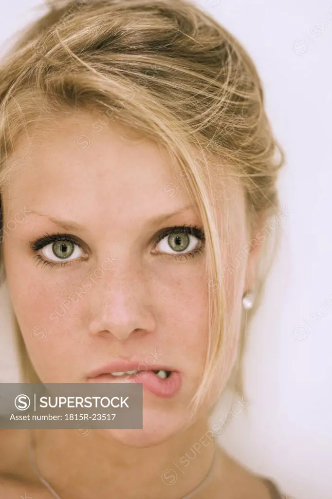 Young woman grimacing, close-up