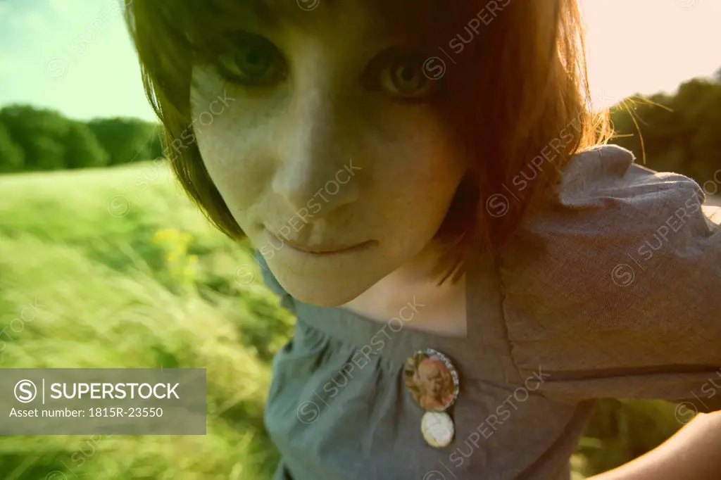 Red headed woman in corn field, portrait