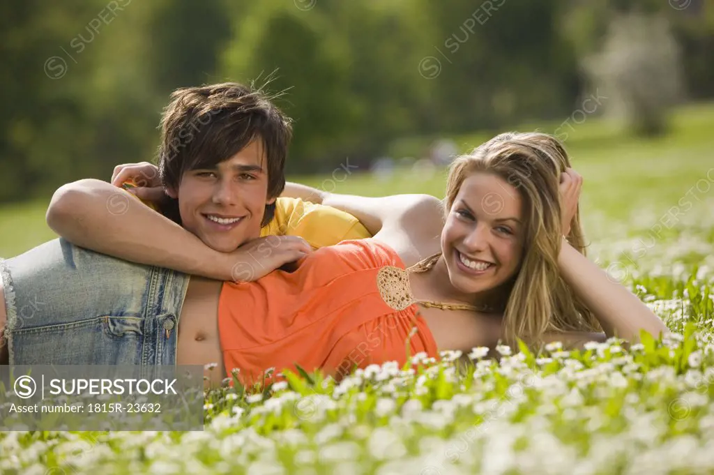 Young couple lying in meadow