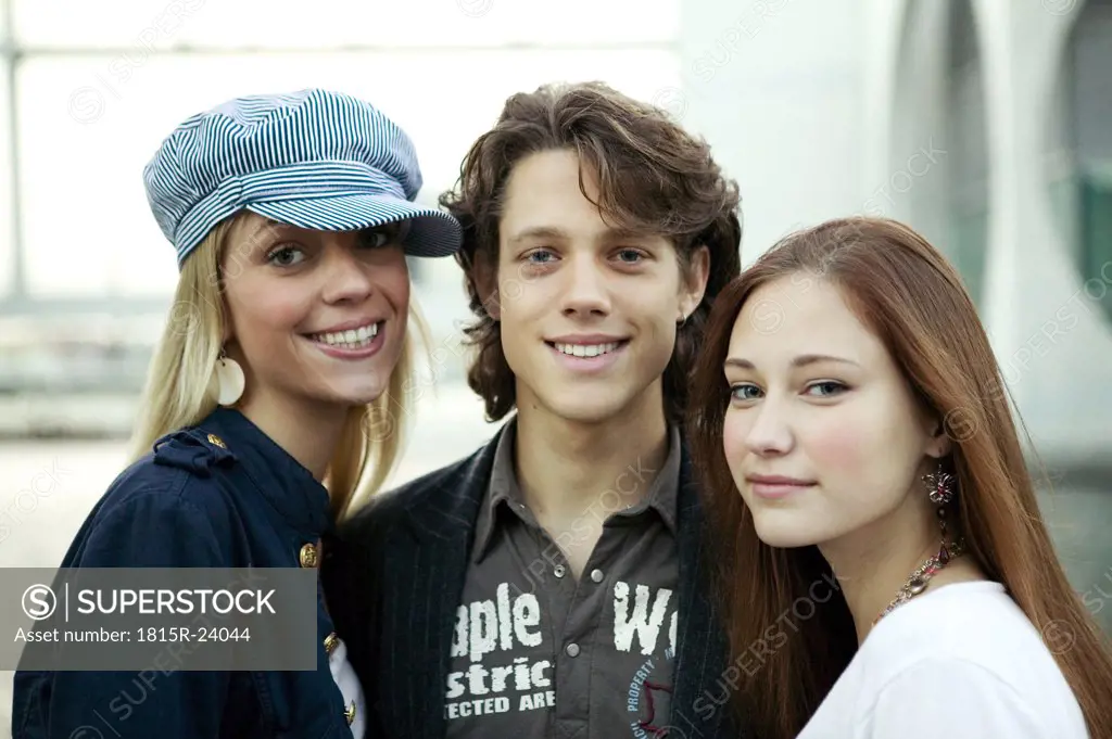 Young man with two young women, portrait
