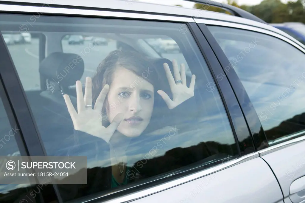Young woman sitting in car