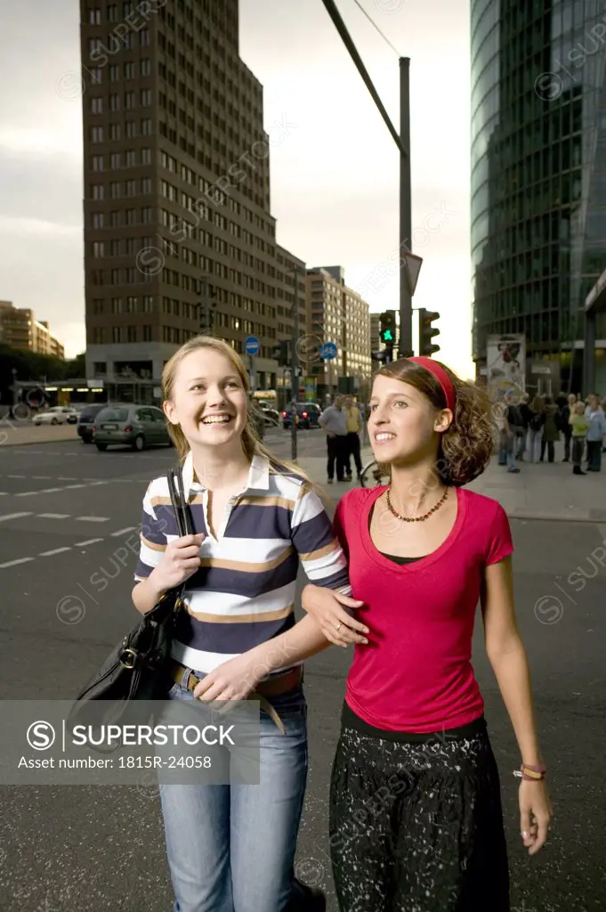 Two girl friends stolling in city