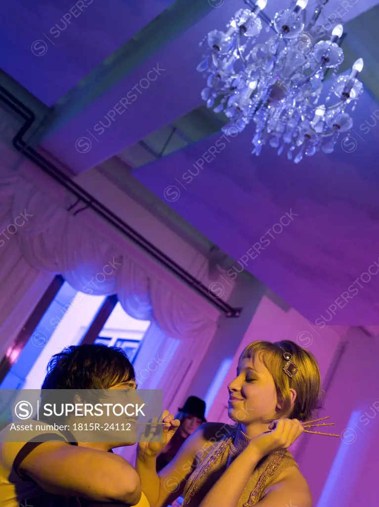 Young couple on party with pretzel sticks