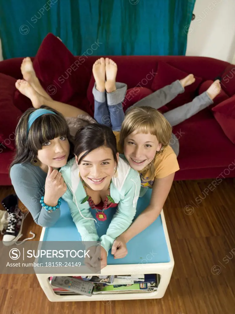 Girls lying on sofa an coffee table