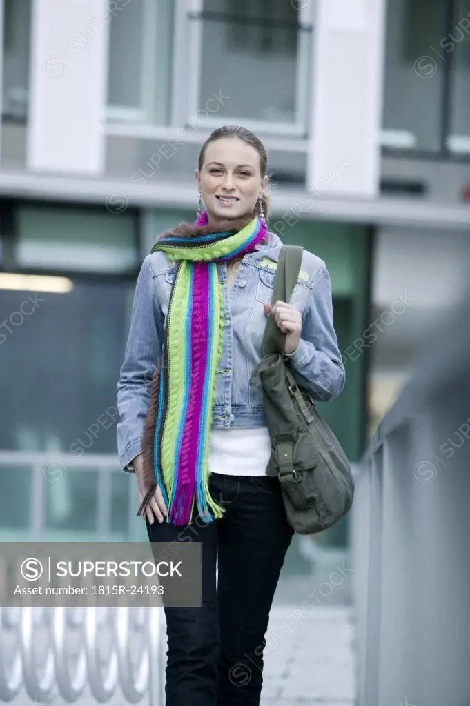 Young woman wearing scarf, walking