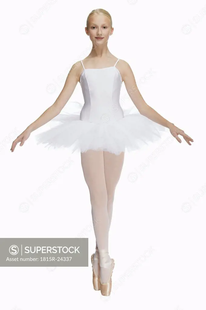 Young ballerina (14-15) standing on pointe in toe shoes,, portrait
