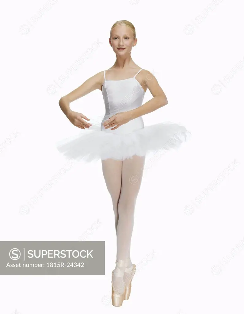 Young ballerina (14-15) standing on pointe in toe shoes,, portrait