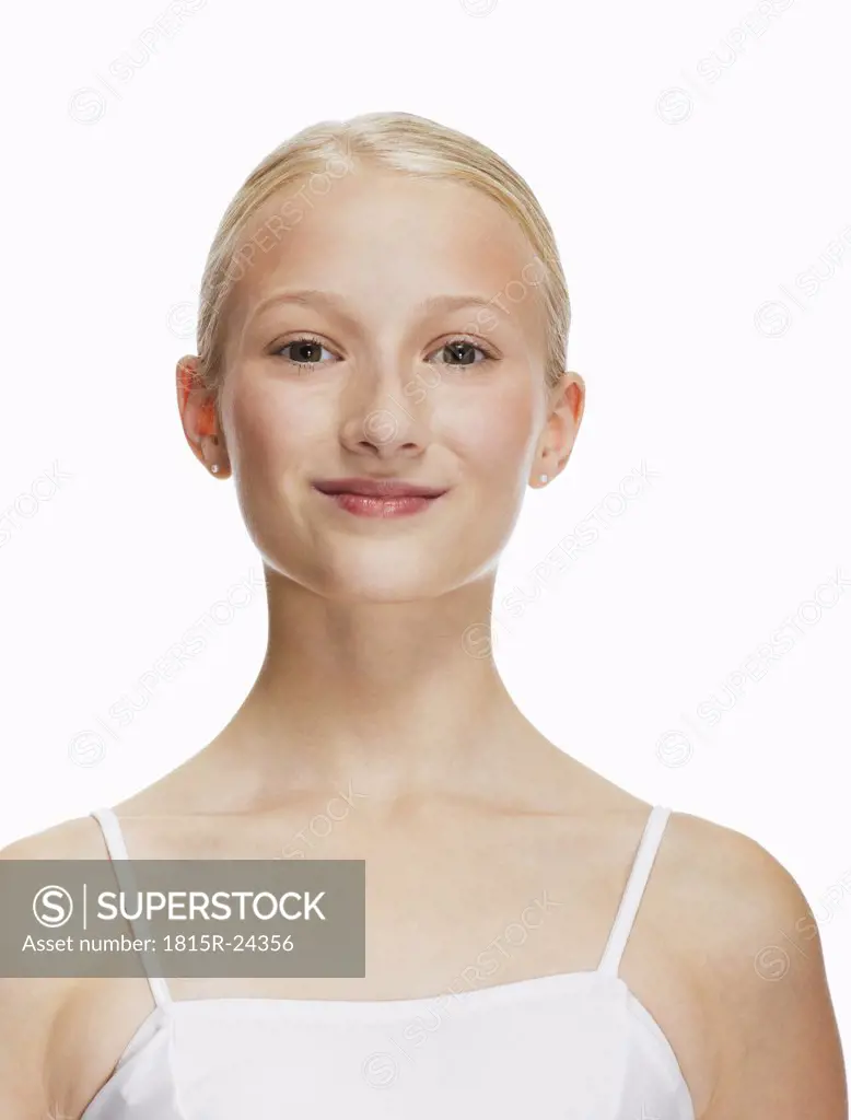 Young ballerina (14-15) smiling, portrait