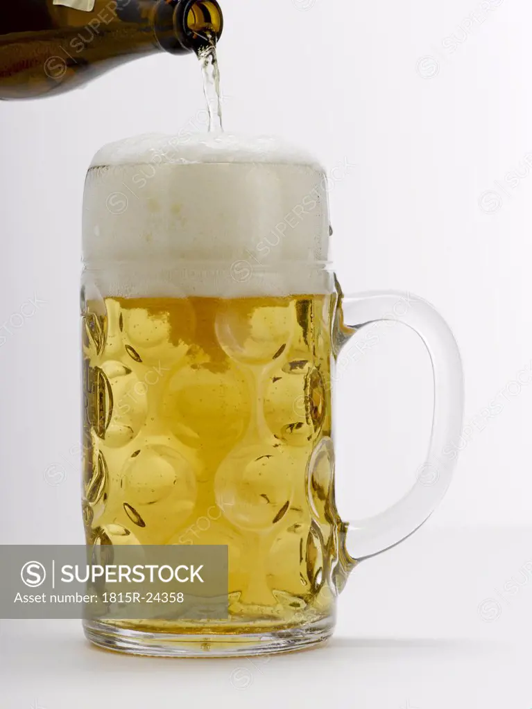 Mug of beer on white background, close-up