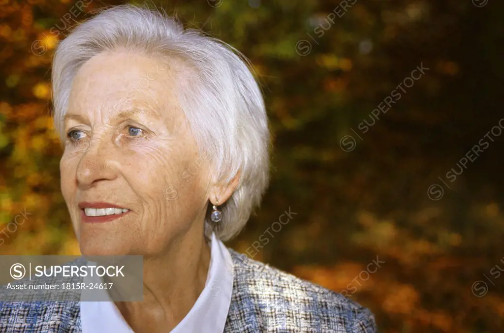 Senior woman looking away, smiling, close up