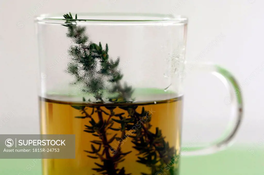 Glass with herbal tea and thyme