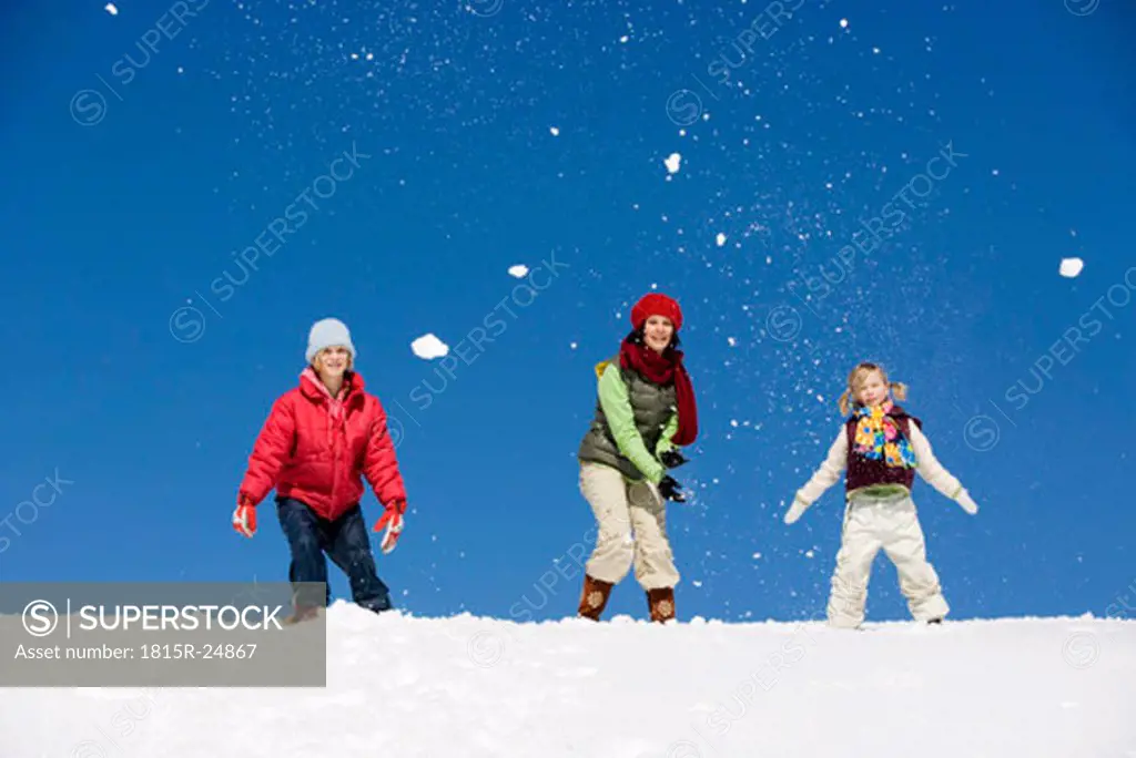Austria, girls (6-17) playing in snow, low angle view