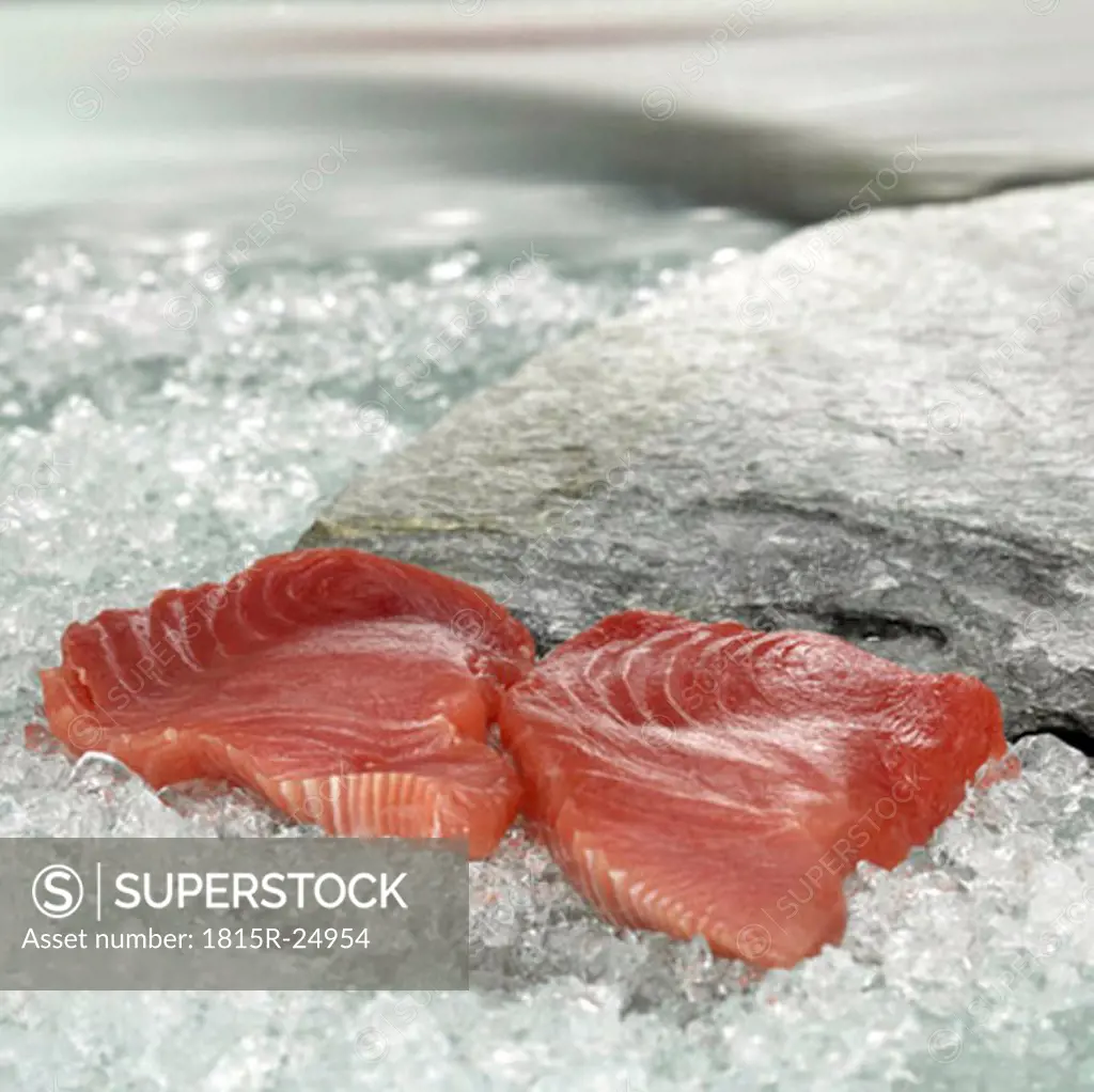 Raw tuna steaks on crushed ice, close-up