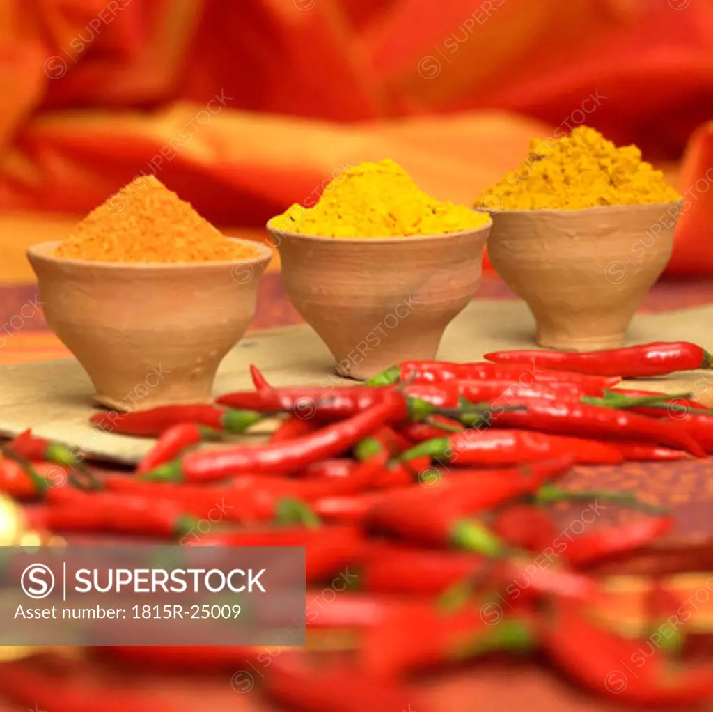 Curry, curcuma and chilli powder with red chillies, close-up
