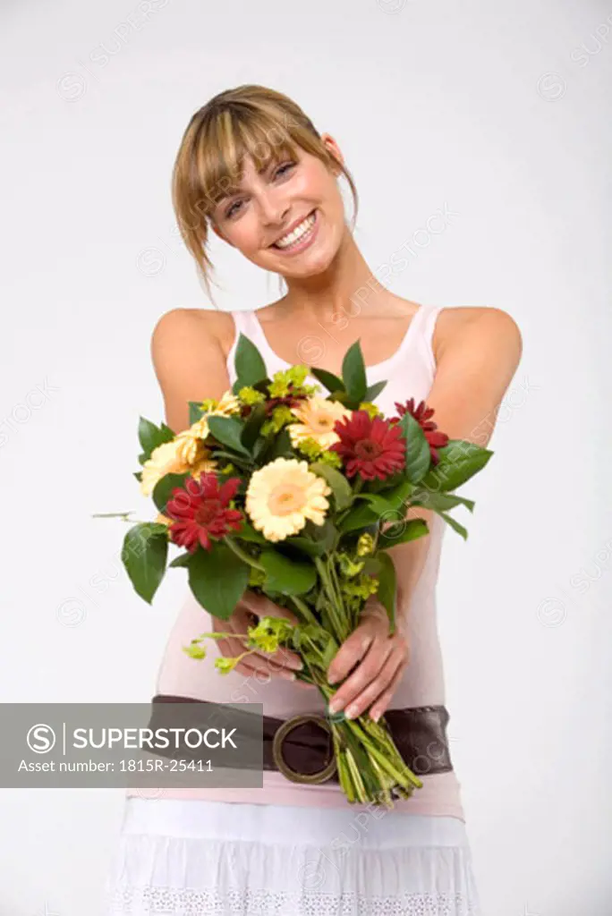 Young woman holding bouquet, smiling, portrait, close-up