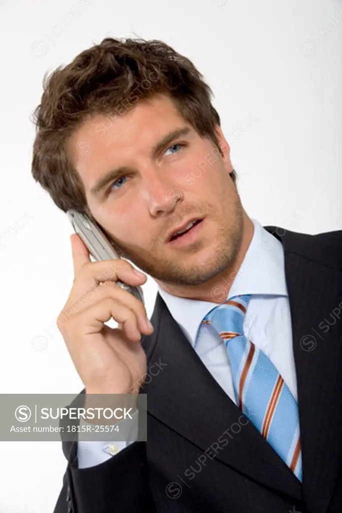 Young business man with mobile phone, portrait