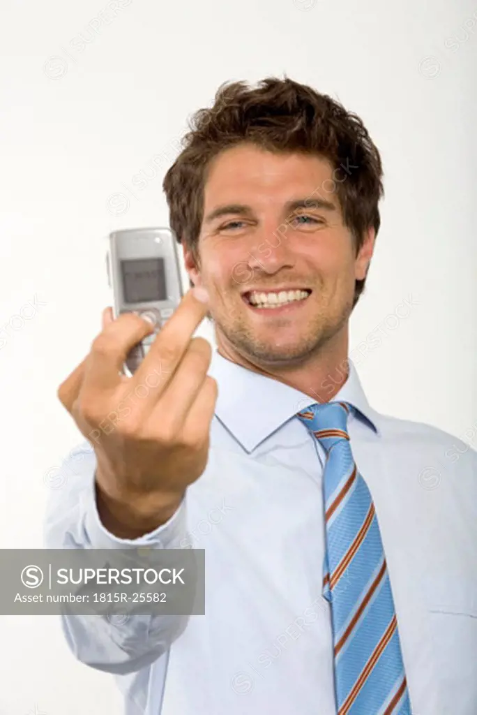 Young businessman photographing self by mobile phone, close-up
