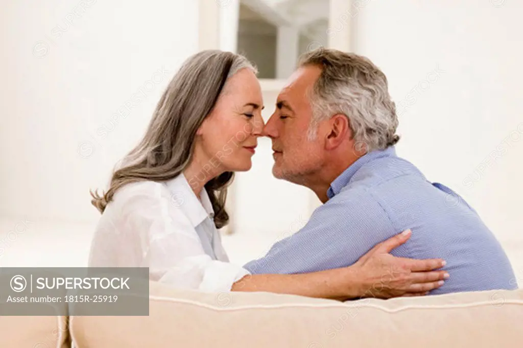 Mature couple rubbing noses together, eyes closed