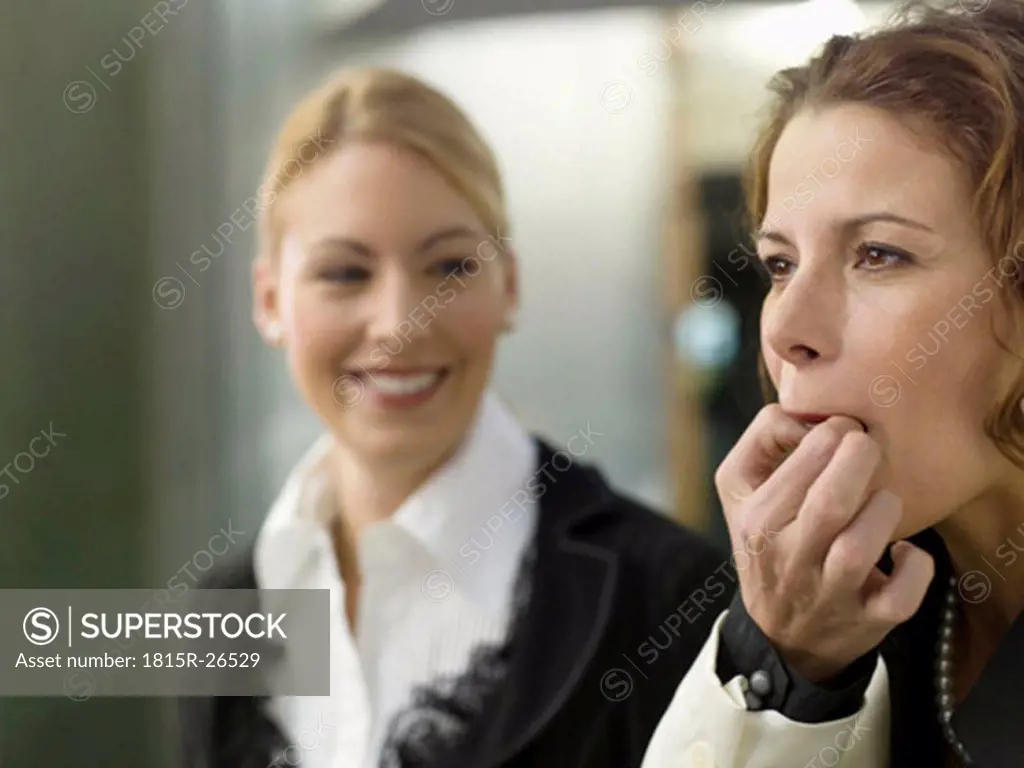 Businesswomen whistling on fingers