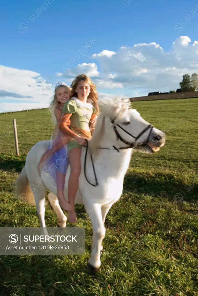 Two girls on horse back