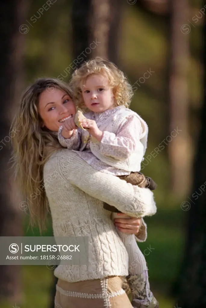Mother carrying daughter, portrait