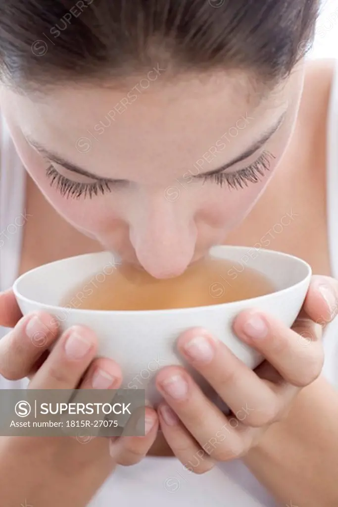 Young woman drinking tea, close-up
