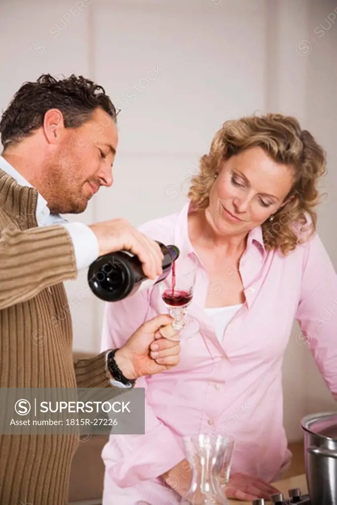 Couple, man pouring wine in glass