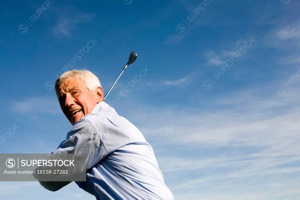 Senior adult man holding golf club