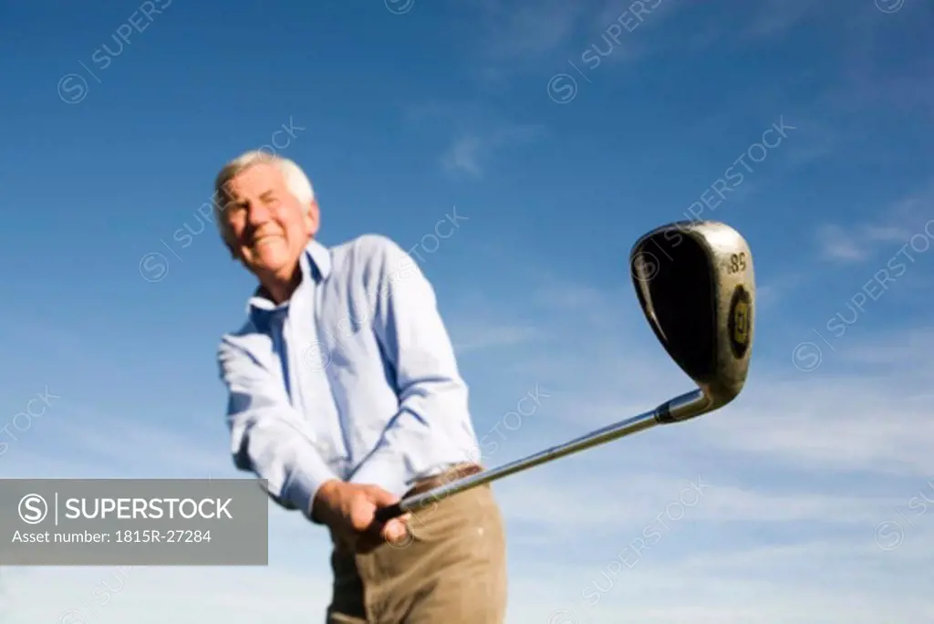 Senior adult man holding golf club