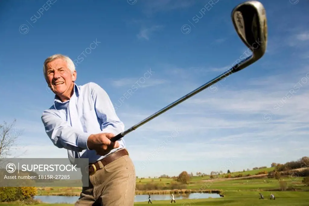 Senior adult man holding golf club