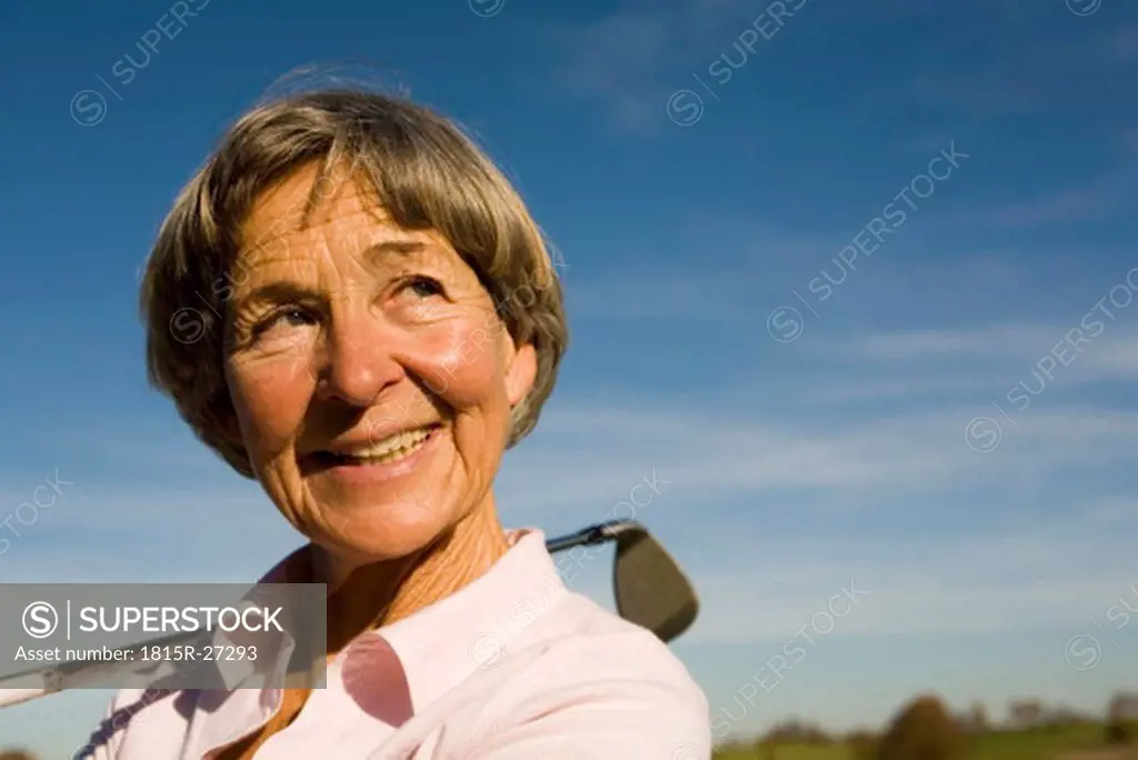 Senior adult woman holding golf club