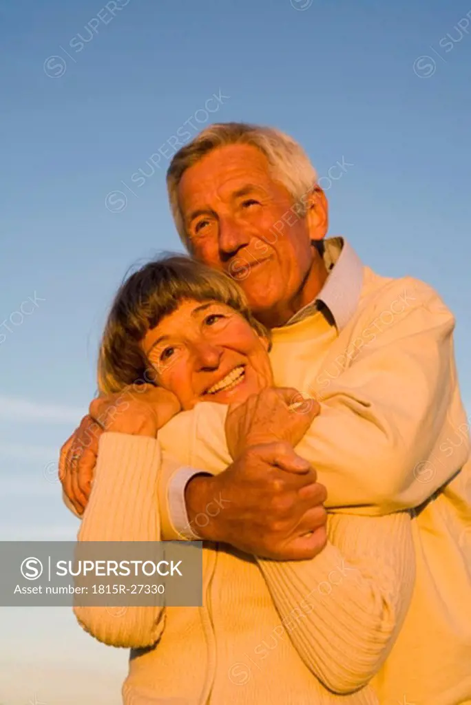 Senior couple embracing, portrait