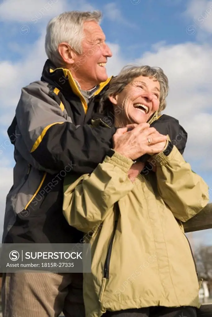 Senior couple, man embracing woman