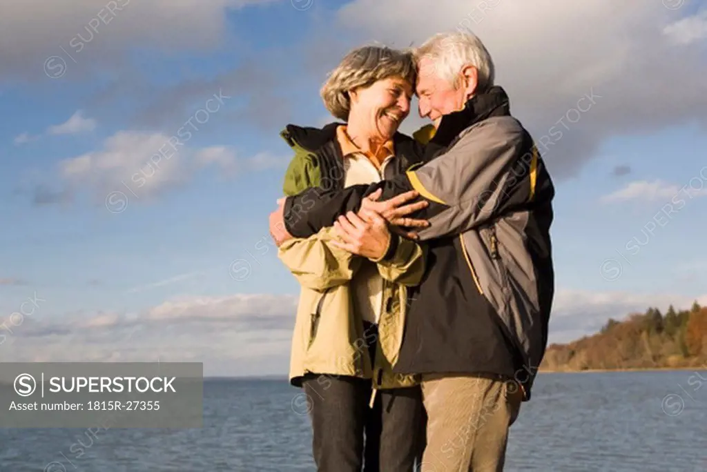 Senior couple embracing, smiling