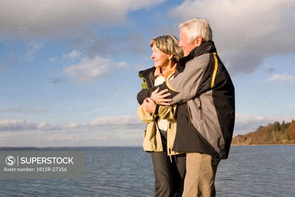 Senior couple embracing, side view