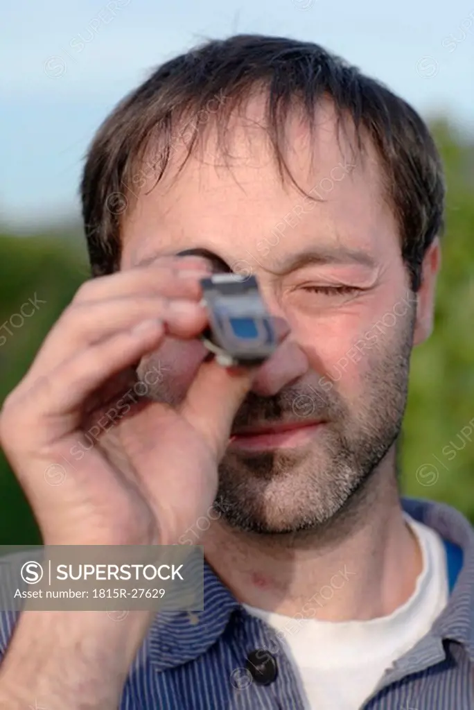 Man using refractometer