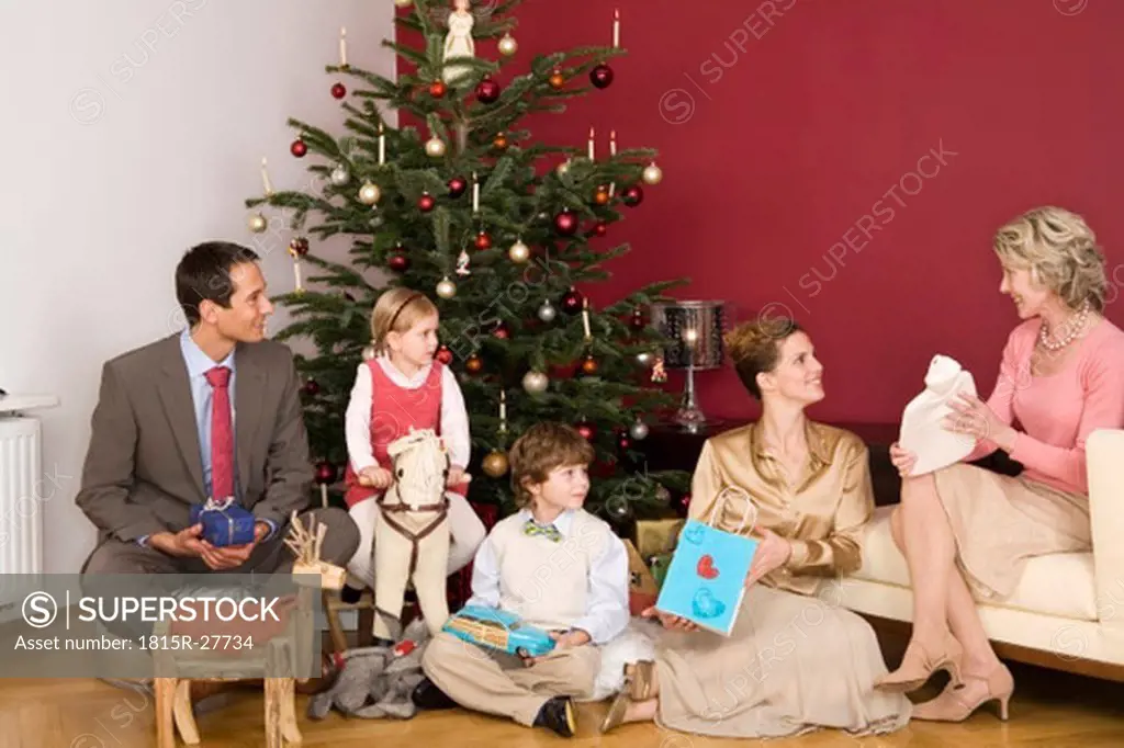 Family sitting under Christmas tree